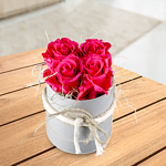 4 pink roses in a hat box